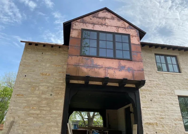 Copper metal panel facade on a stone building for Metal Roof Coating in Pigeon Forge